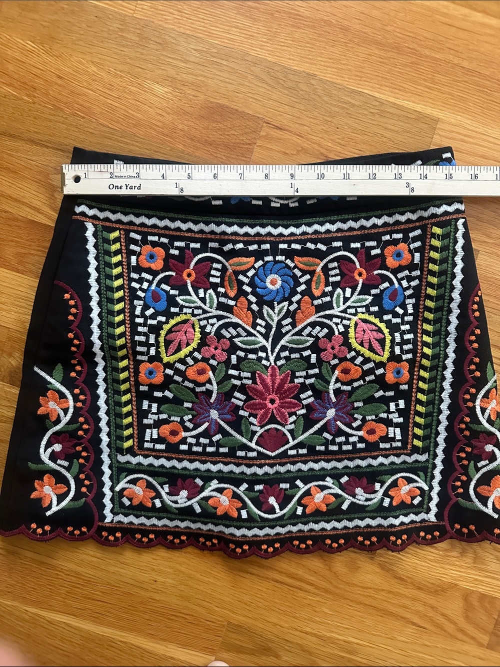 Lulus size small, black mini skirt w/ beautiful bright stitched flower detail